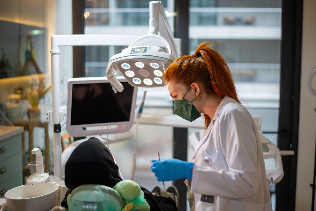 Female dentist conducting a dental procedure in a bright, modern clinic setting.