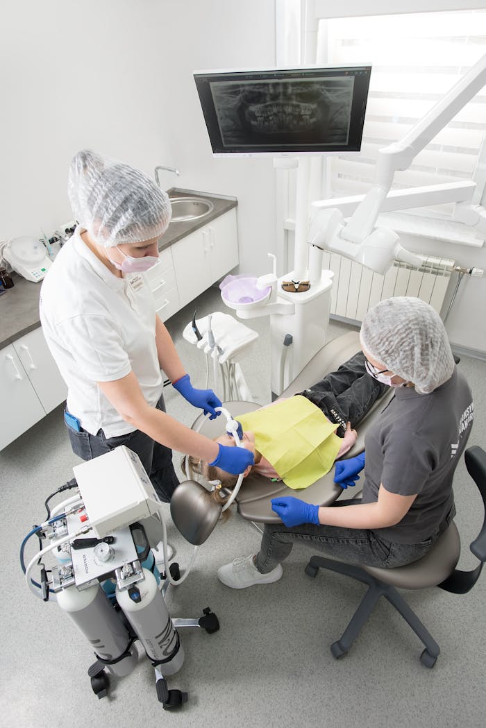 Overhead view of a dental procedure with a dentist and patient, showcasing modern dental equipment and care.